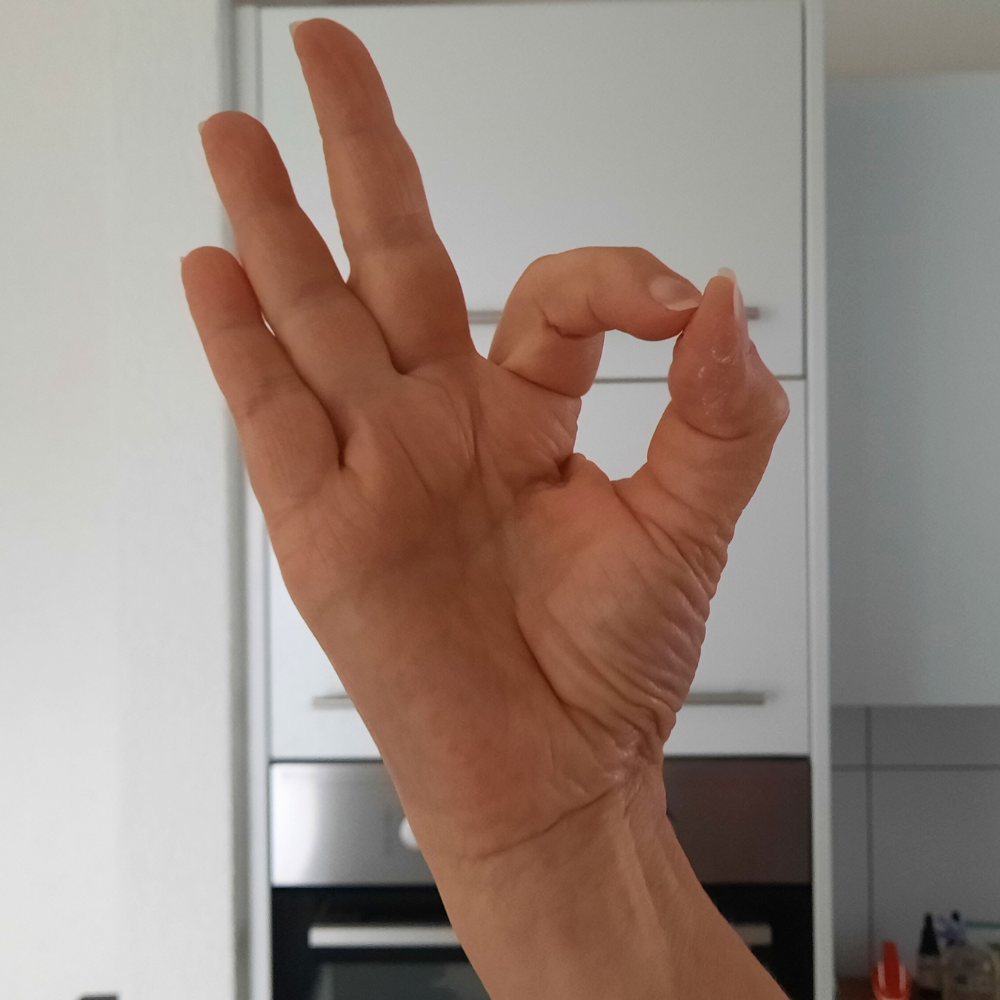 Picco-bello-Handzeichen